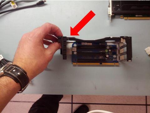 2 Open the PCI card support bracket on the back of the