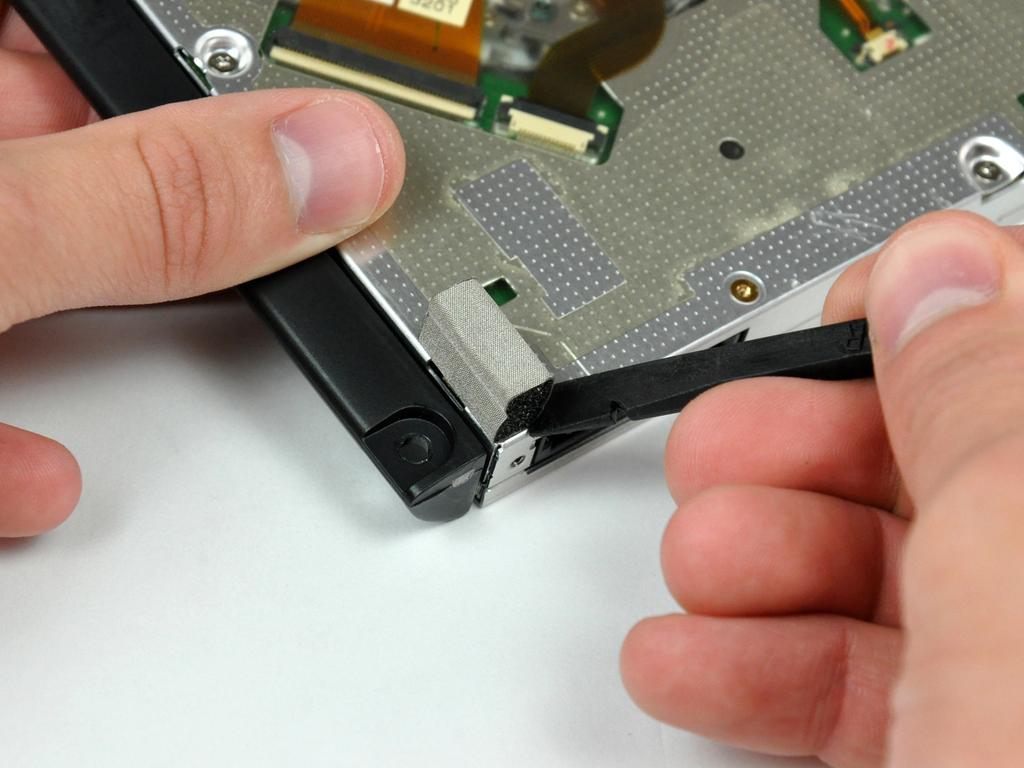 If the adhesive gets dirty or will not stick to your new optical drive, place some double-sided tape under the two