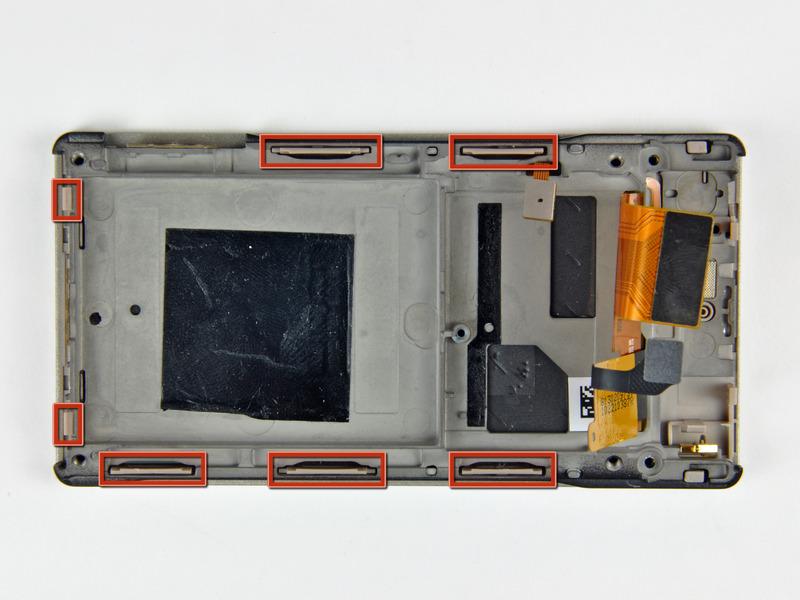 Step 17 The inner chassis attaches to the front case by several clips around its perimeter (shown in red).