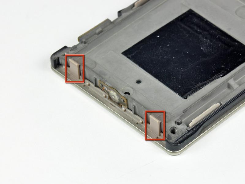 The five plastic clips along the side of the Zune lock onto small aluminum tabs cast into the inner chassis.