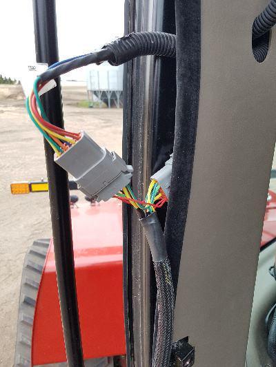 Run the cable to the bottom to connect to the CNH- JD Bridge.