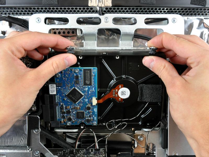 Step 14 Rotate the top of the drive toward yourself, then lift the hard drive straight up off its