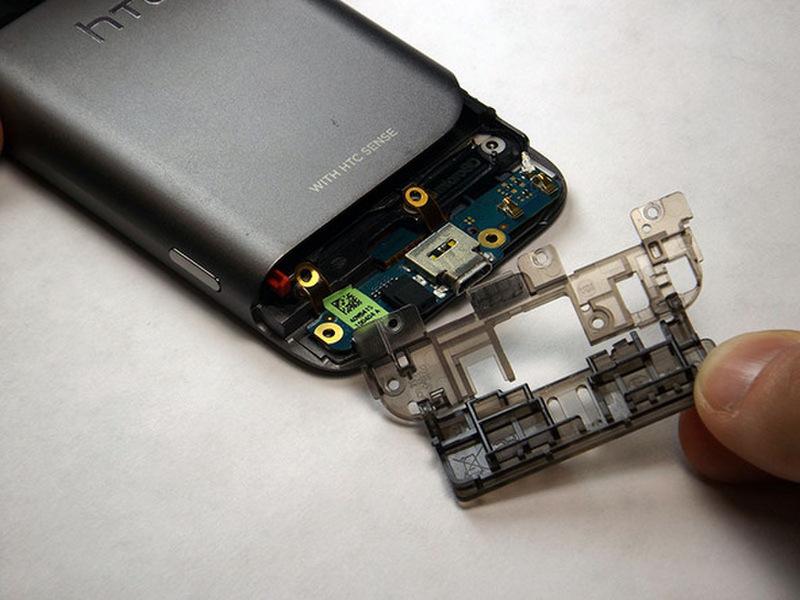 Step 5 Remove plastic flap from phone Once the screws are