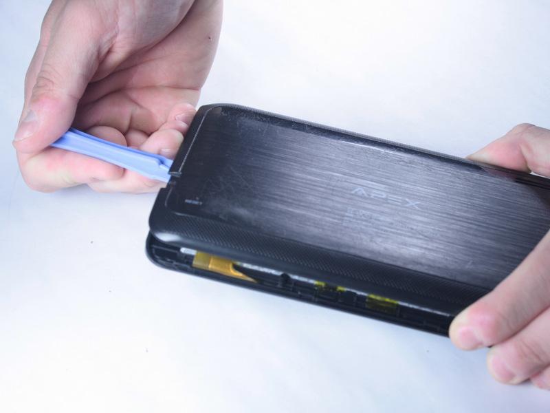 Run the plastic opening tool along the sides of the tablet while