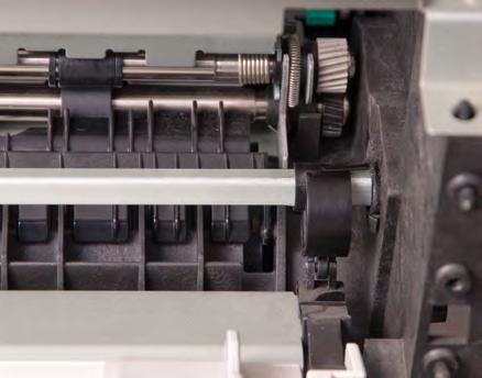 It is held in this position by a white plastic lever, which is in turn held in position by a cam and solenoid (Fig. F). b. There is a black plastic cam on each end of the shaft (inside the printer chassis).
