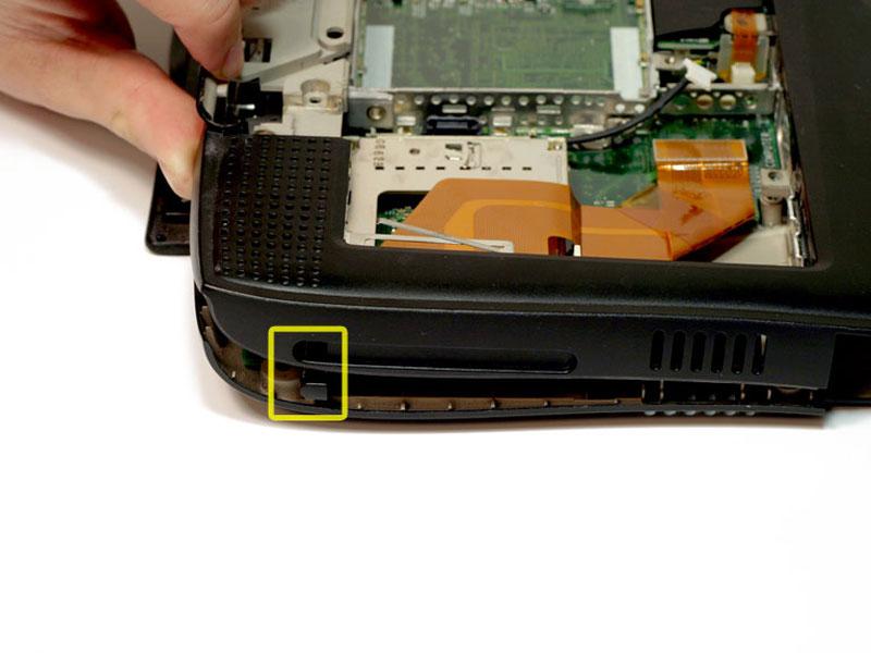Step 36 The PC card eject button on the laptop's left side prevents the upper casing from lifting up.