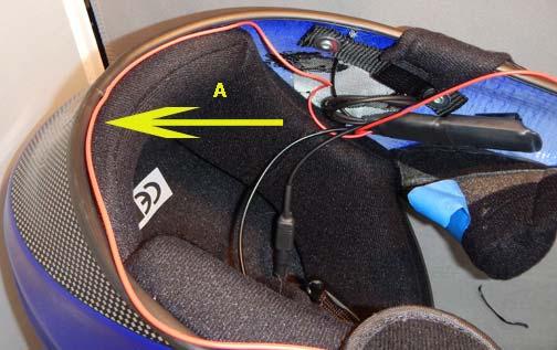 A. With the microphone wire already in-place, gently push the left speaker wire between the liner and shell.