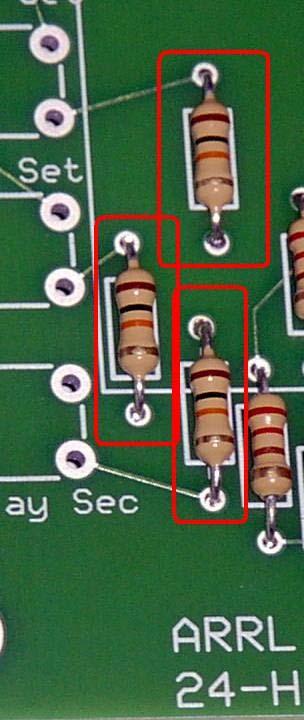 Locate the 3 10K-om resistors (brown/black/orange) and install them in the indicated locations flush