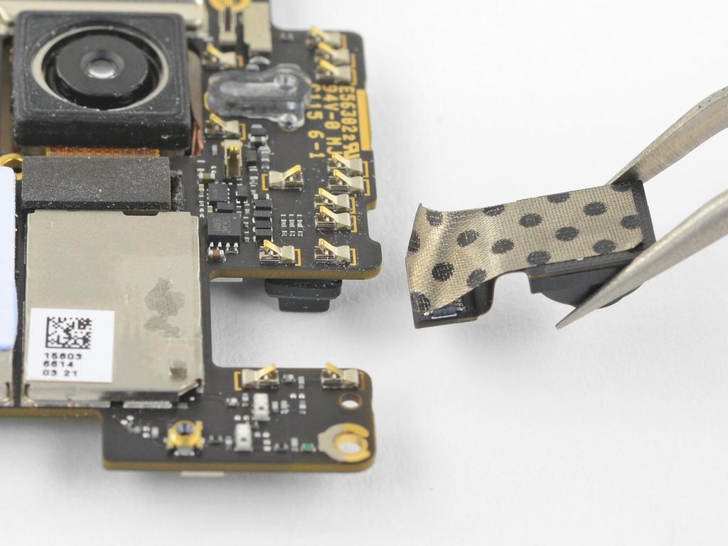 Step 17 Flip the motherboard over again. Peel the front-facing camera away from the motherboard with its tape. Remove the front-facing camera.