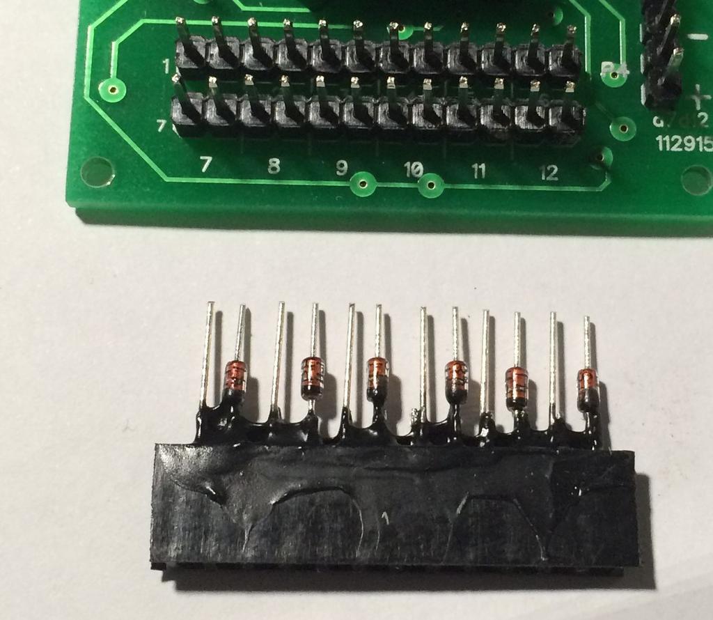 Notice that each two pins side by side represents one switch connection. The header below has been modified with diodes.
