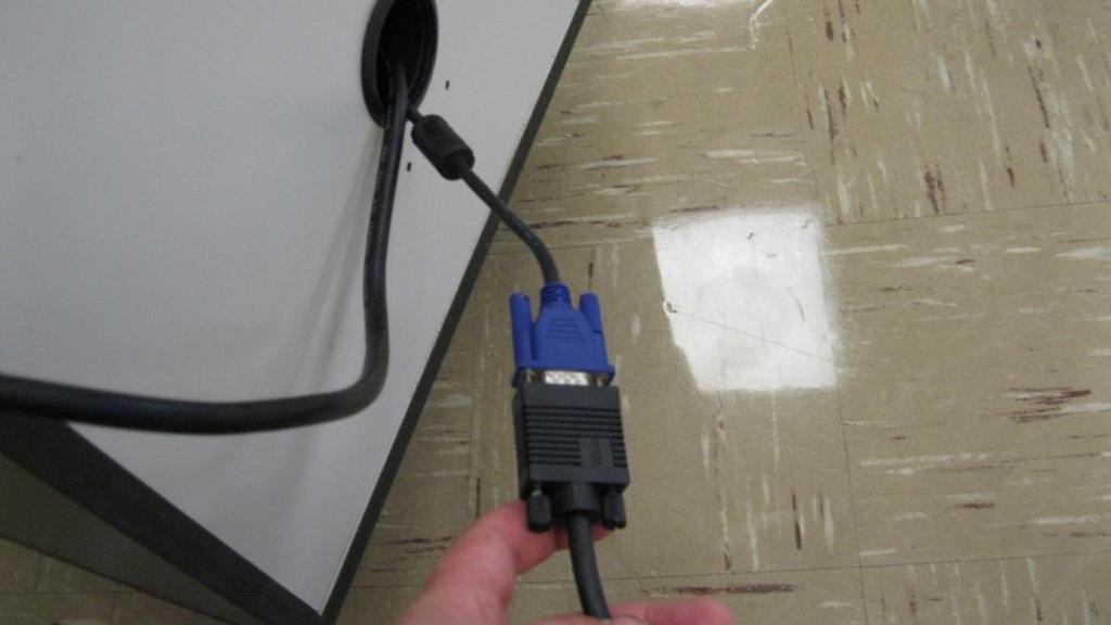 9. Connect the black video cable (coming from the wall running to the projector on the ceiling), to the blue end of the video cable coming out of